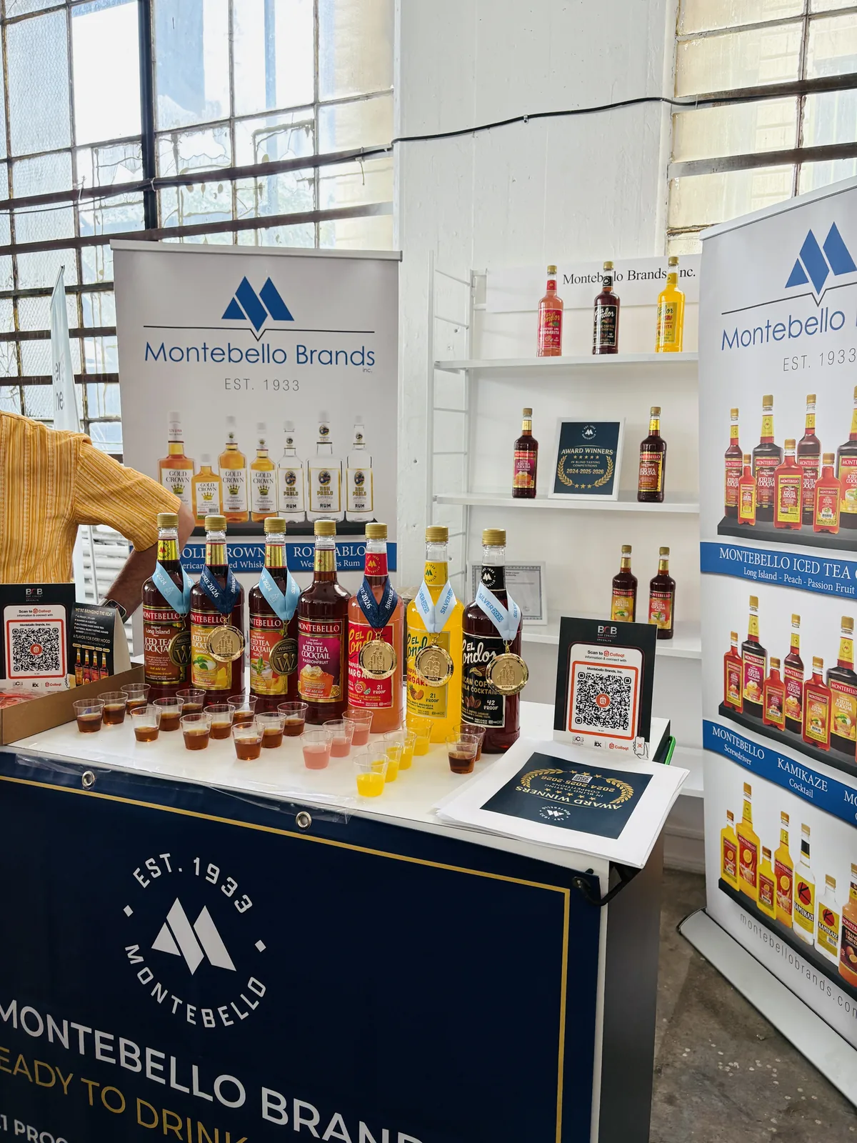 Tasting cups poured in front of Long Island Iced Tea and El Condor bottles